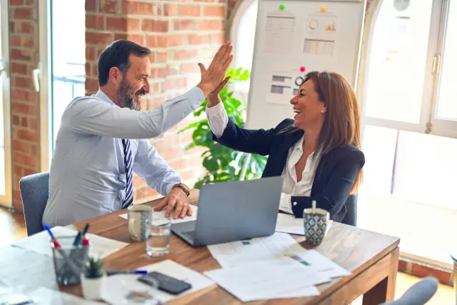 High Five To Celebrate A Business Transaction